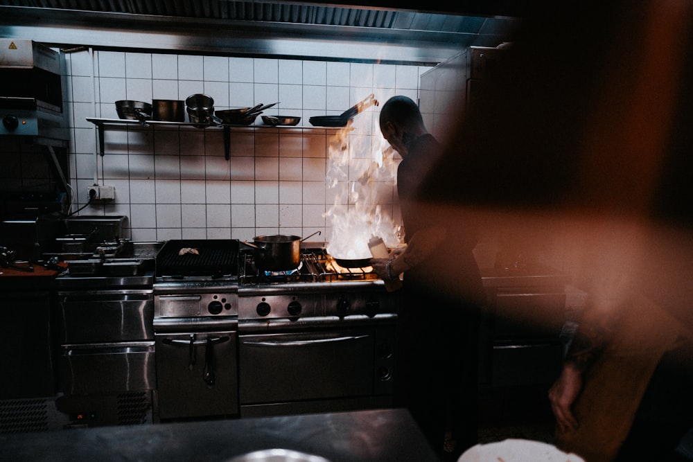 person doing cook inside kitchen