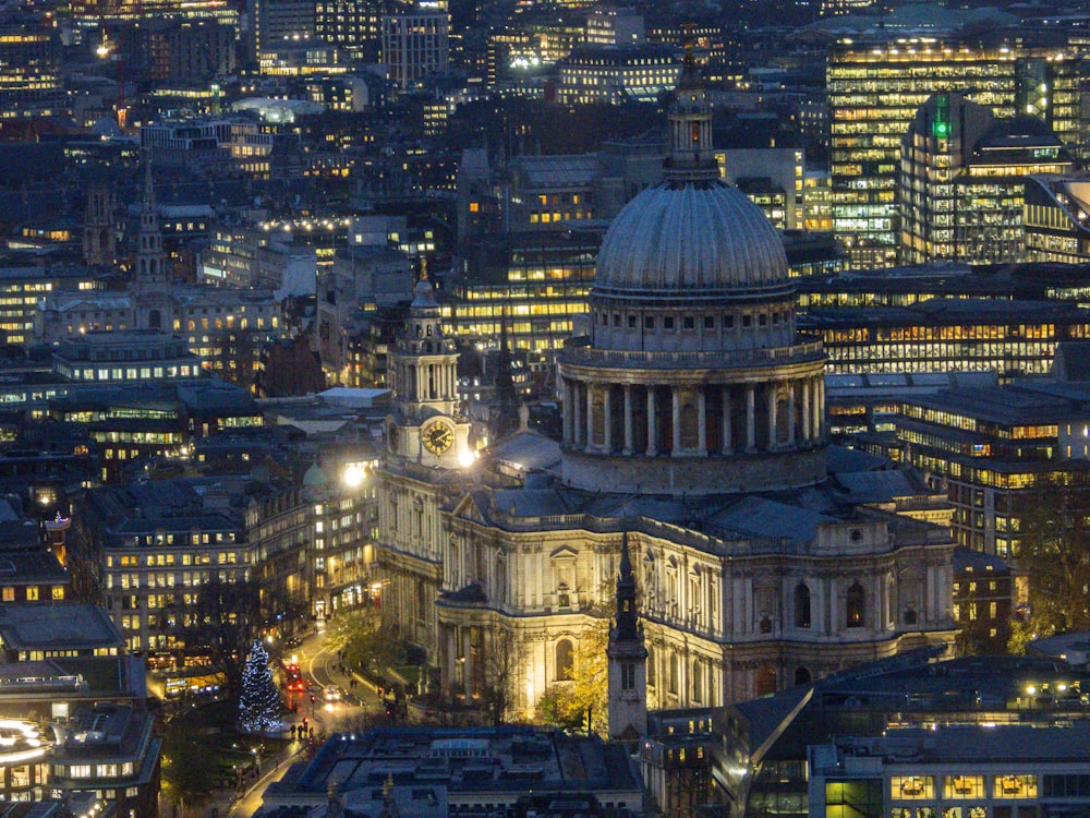 city with high-rise buildings and dome historic building during night time