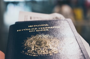 a close up of a person holding a passport
