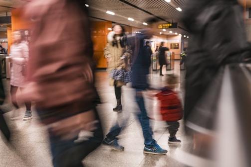 Close-up of the camera tracking multiple moving targets in a busy transportation hub.