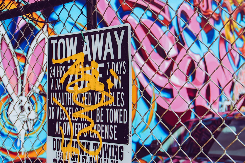 Tow Away signage on chain-link fence