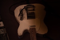 A rare vintage electric guitar resting on a pine-green velvet cloth.