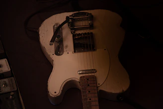 A worn vintage guitar undergoing complete refinishing to restore its shine.