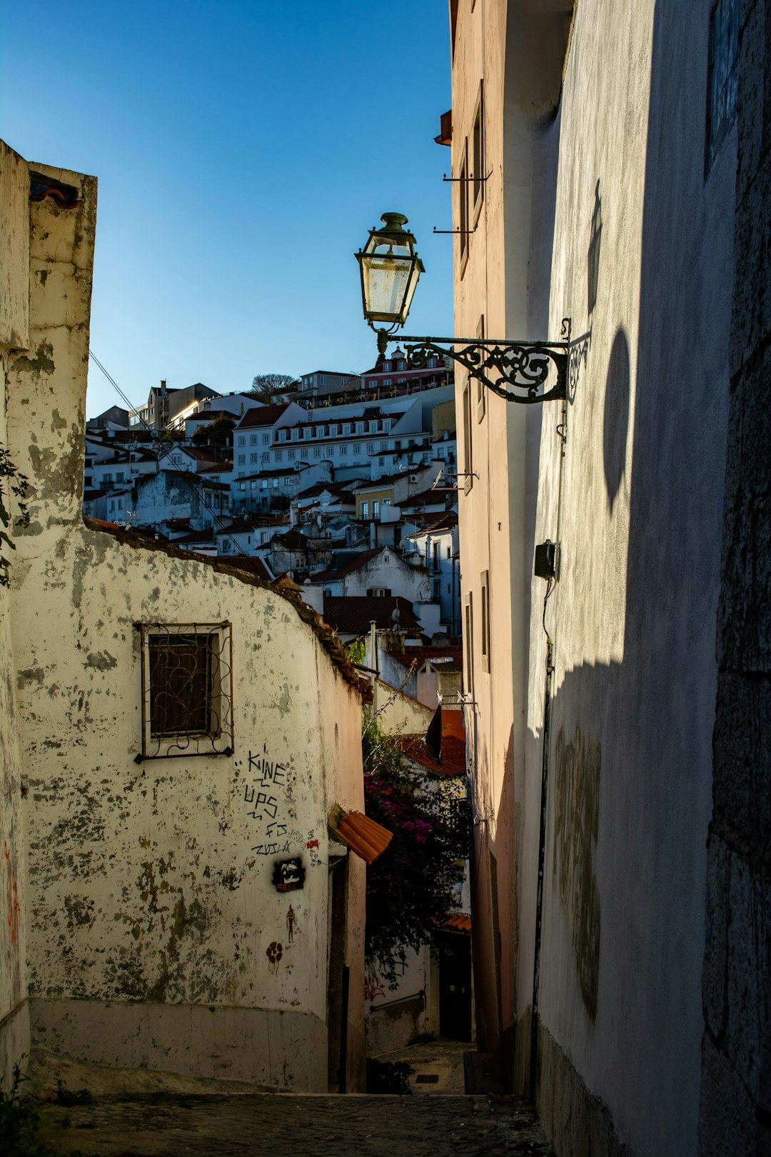 Narrow and steep alley blending the past and the present of Lisbon