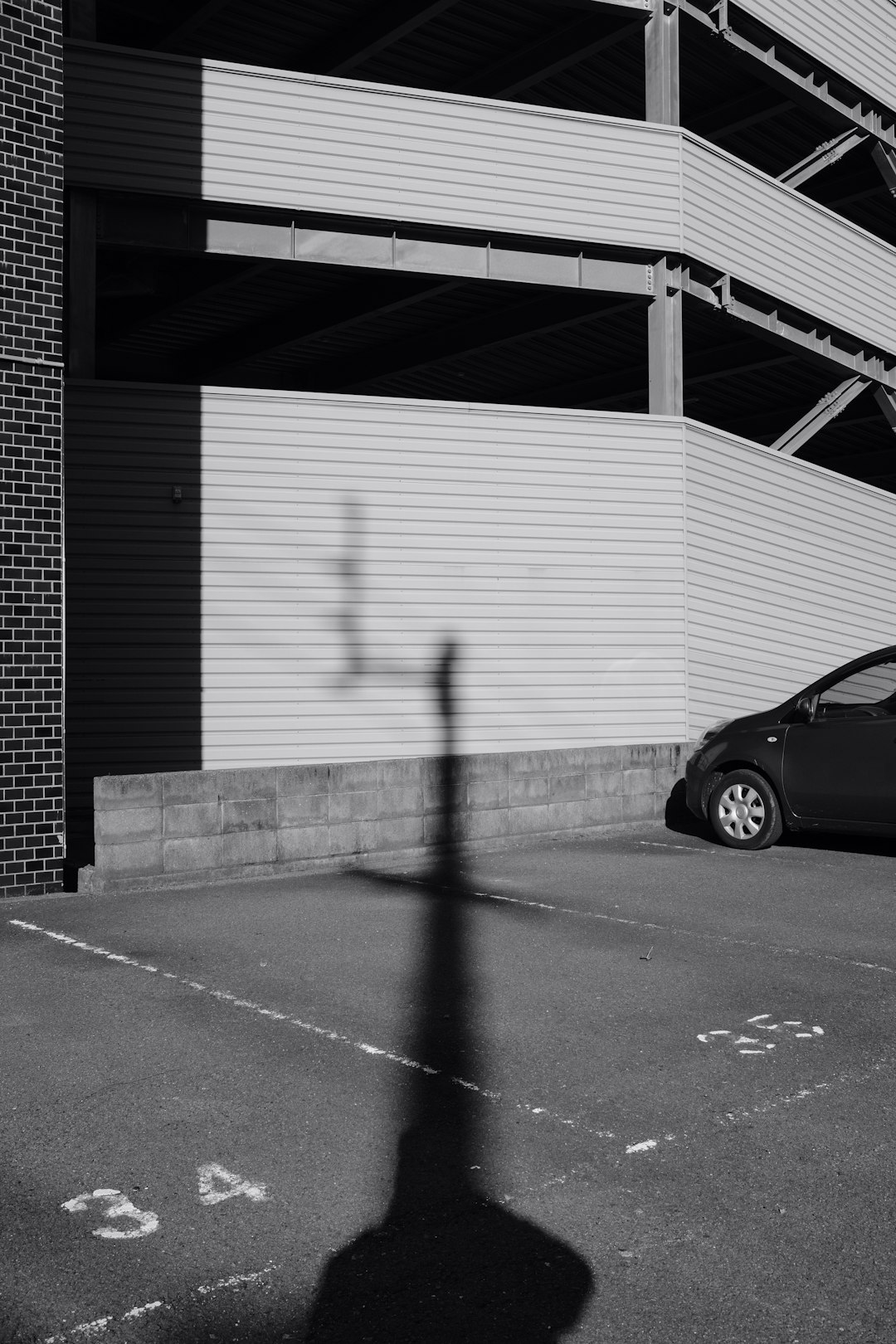 black car parked beside wall