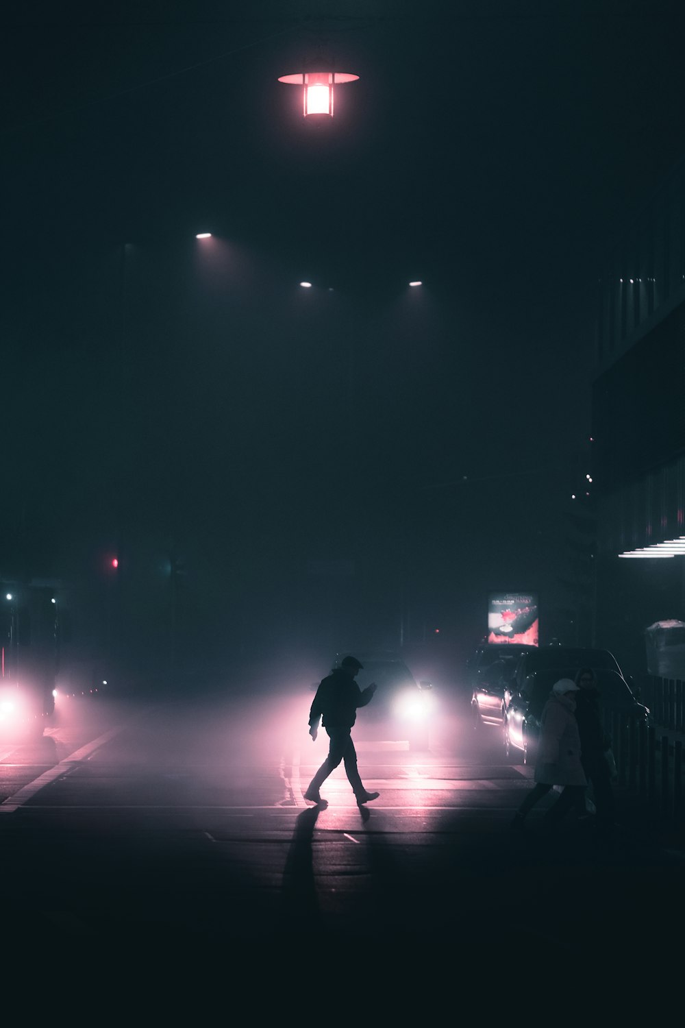 person crossing on road during night time