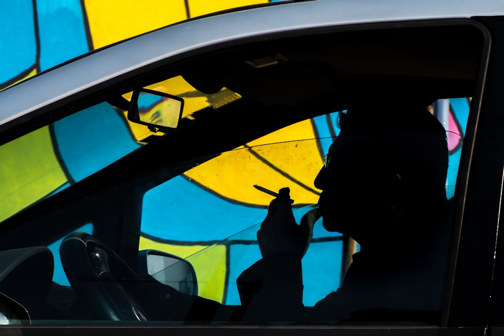 man smoking in vehicle