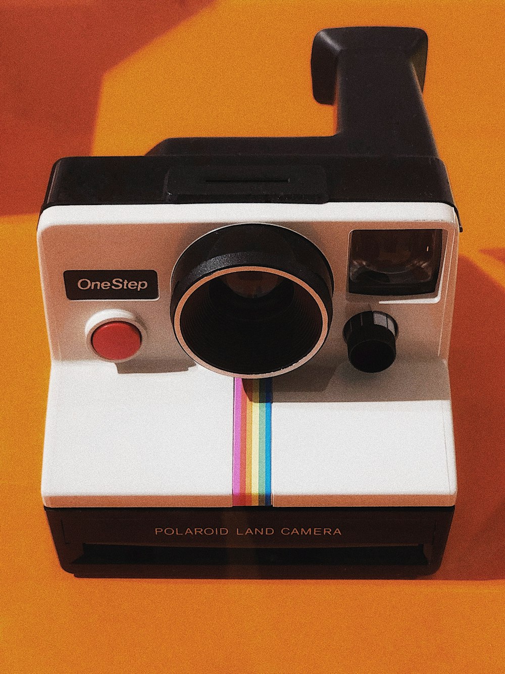 white and black Polaroid OneStep land camera