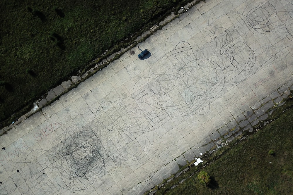 an aerial view of a street with a car parked on it