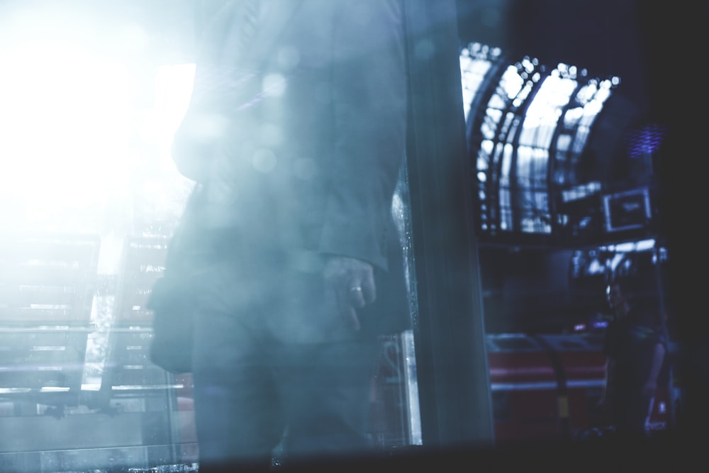 a man standing in front of a window in a building