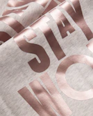 Bold typography design featuring a classic Texas phrase on a heather gray tee.