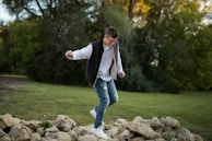 A young person jumping joyfully outdoors, symbolizing financial freedom with meindepot.