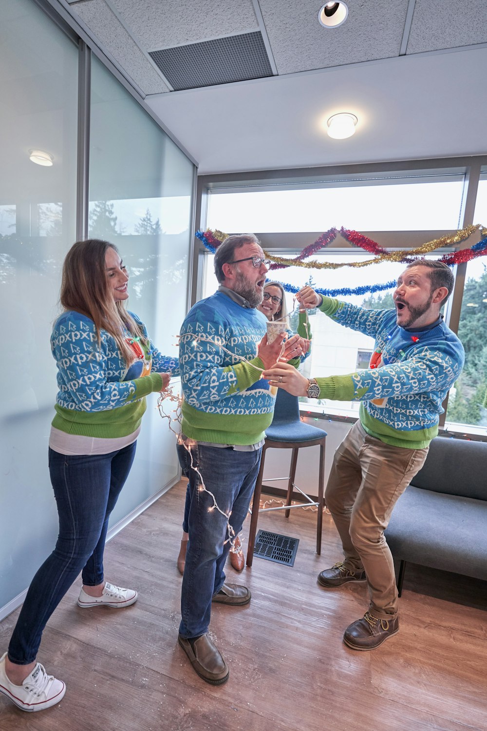 two men and woman celebrating inside office