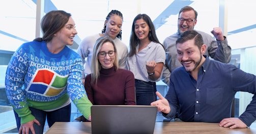 woman in maroon sweater using laptop