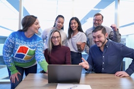 woman in maroon sweater using laptop