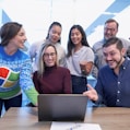 woman in maroon sweater using laptop