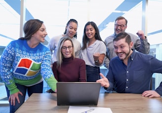 woman in maroon sweater using laptop