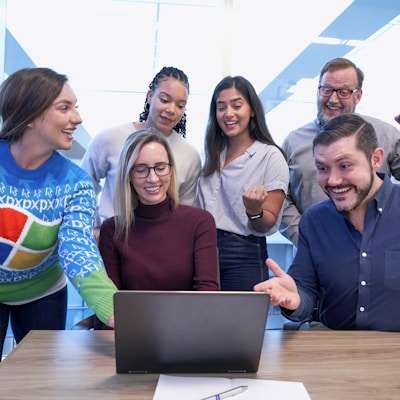 woman in maroon sweater using laptop