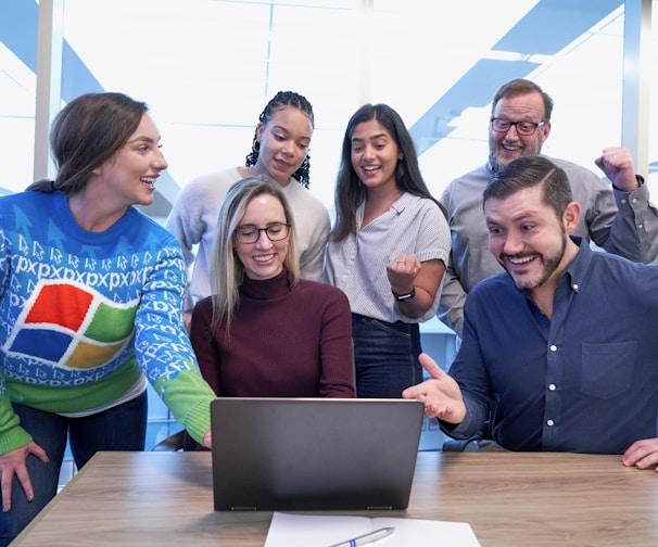 woman in maroon sweater using laptop