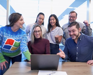 woman in maroon sweater using laptop