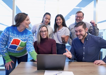 woman in maroon sweater using laptop