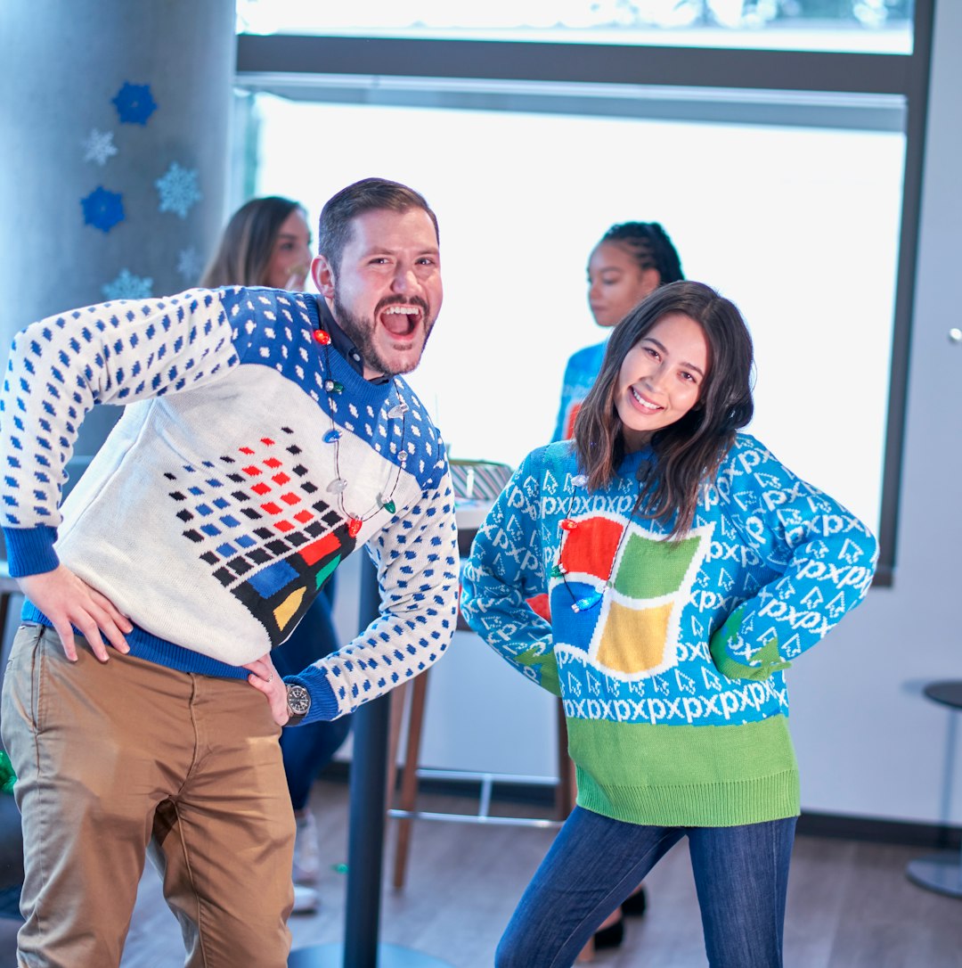 man and woman wearing Windows sweater