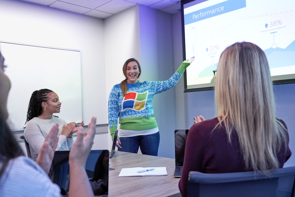 a woman giving a presentation to a group of people