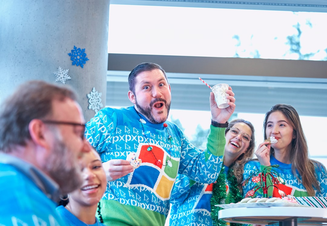 group of people wearing blue sweaters