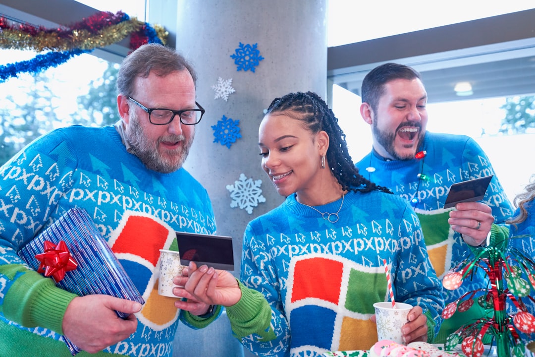 three person wearing Windows XP print sweaters