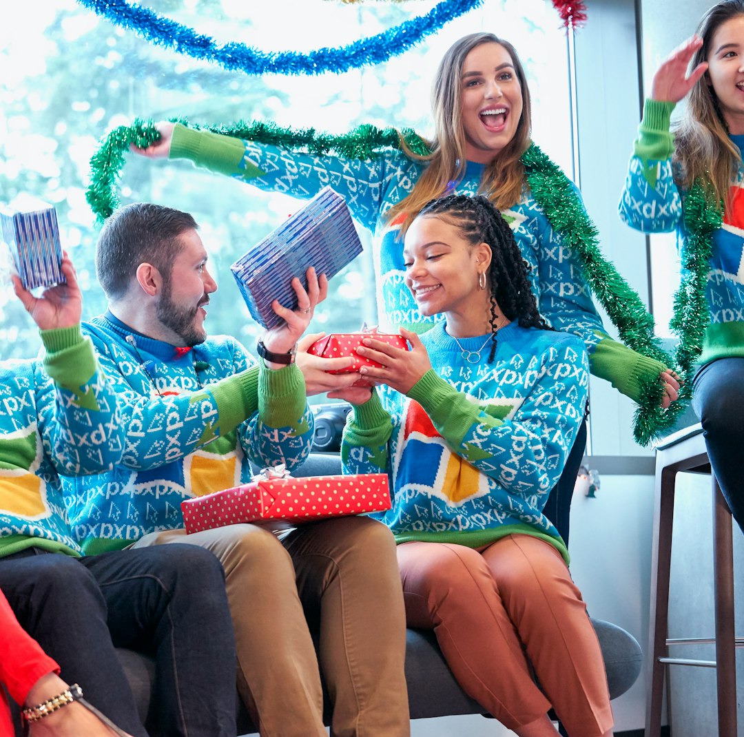 three person in blue Windows logo print sweaters sitting on sofa