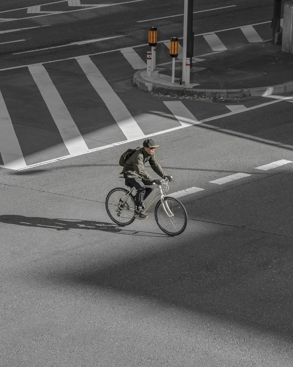 man riding bicycle on road during daytime