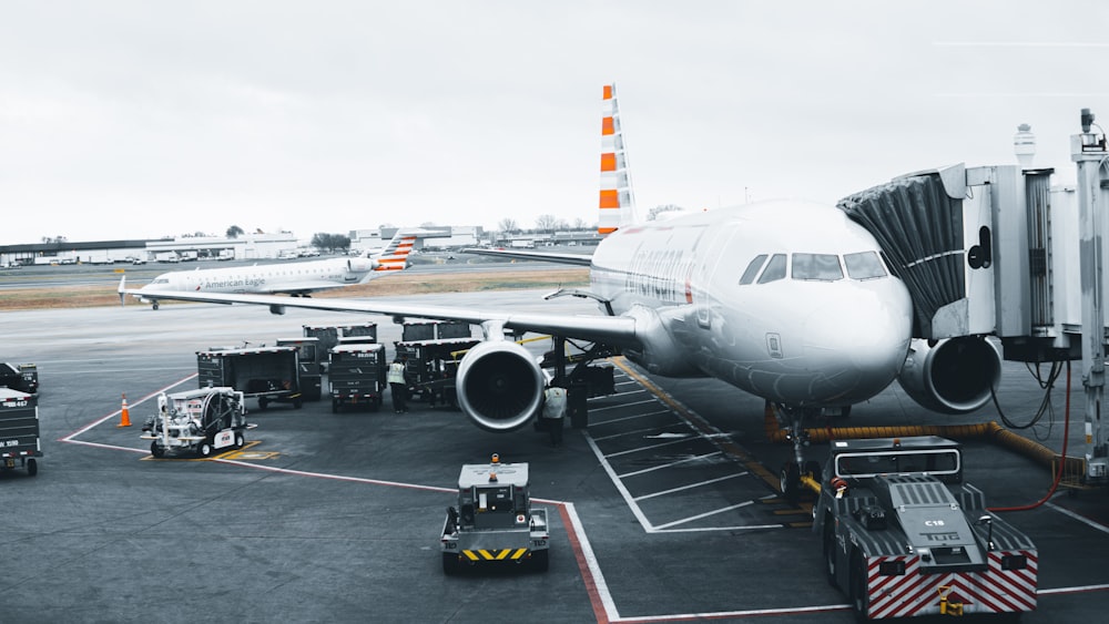 white airplane in airport during daytime