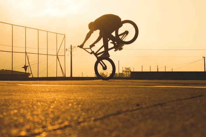 A rider standing with a BMX bike before a demonstration, representing the athletes leading the national anti-bullying tour