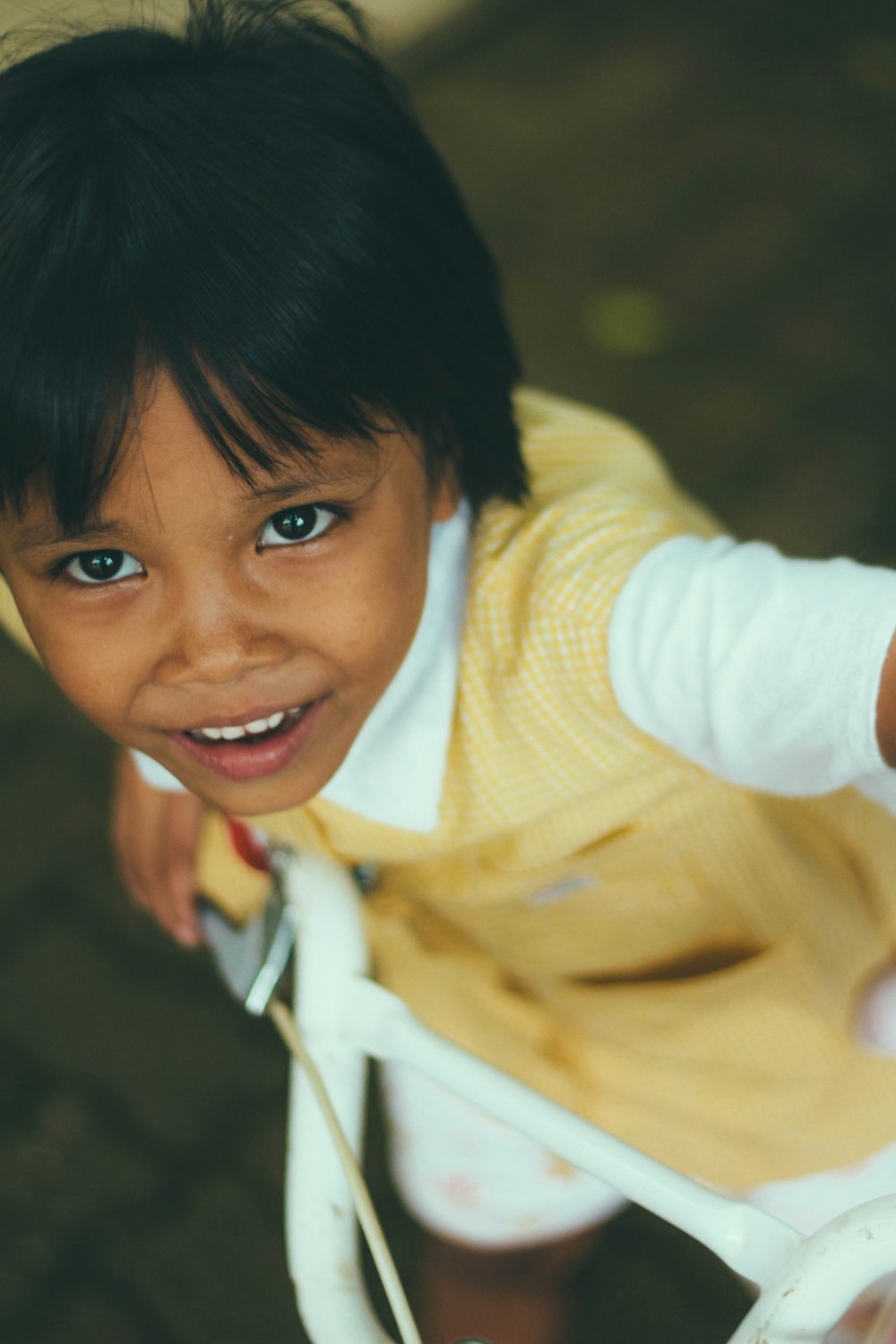 boy wearing white and yellow dress