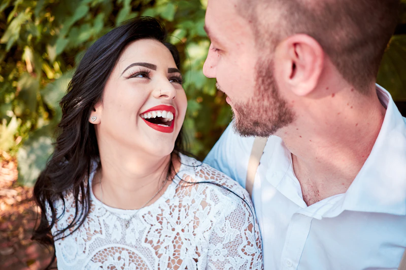 man and woman standing beside a plant