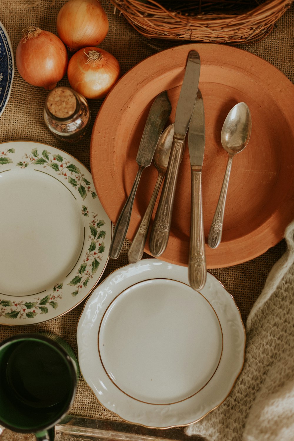 a table topped with plates and bowls filled with food