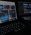A sleek, dark-themed workspace with a glowing laptop and smartphone displaying analytics dashboards.