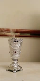 High-resolution image of a scented bracelet resting beside a small incense burner