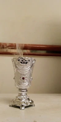High-resolution image of a scented bracelet resting beside a small incense burner