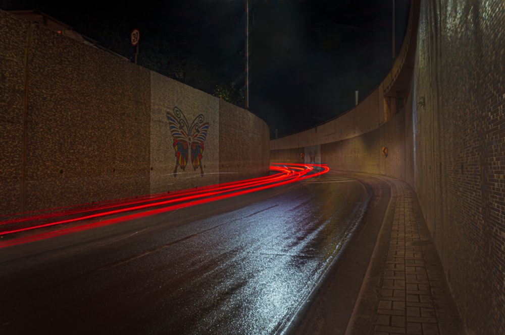 time-lapse photography of road between walls
