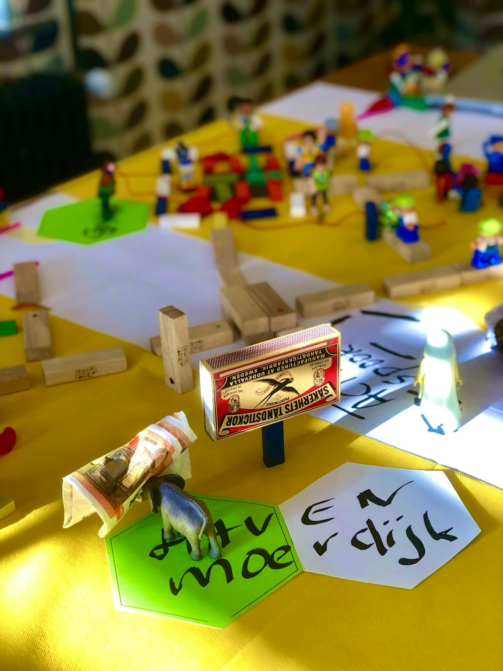 a yellow table topped with legos and a yellow table cloth