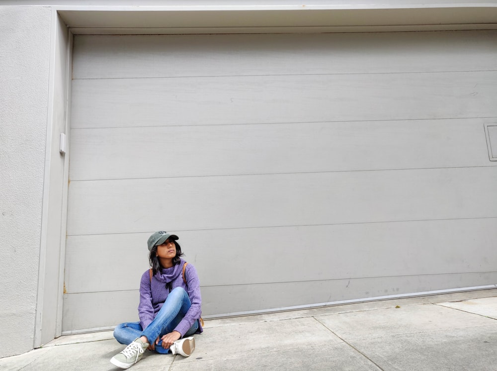 woman sitting near garage door