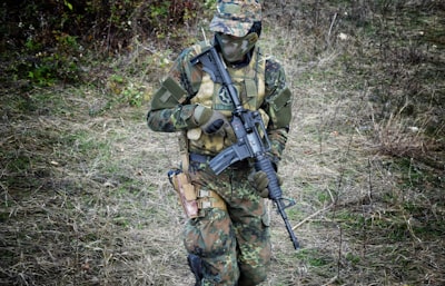 soldier holding rifle army teams background