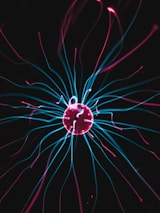 A close-up of plasma swirling inside a fusion reactor chamber, illuminated in vibrant colors.