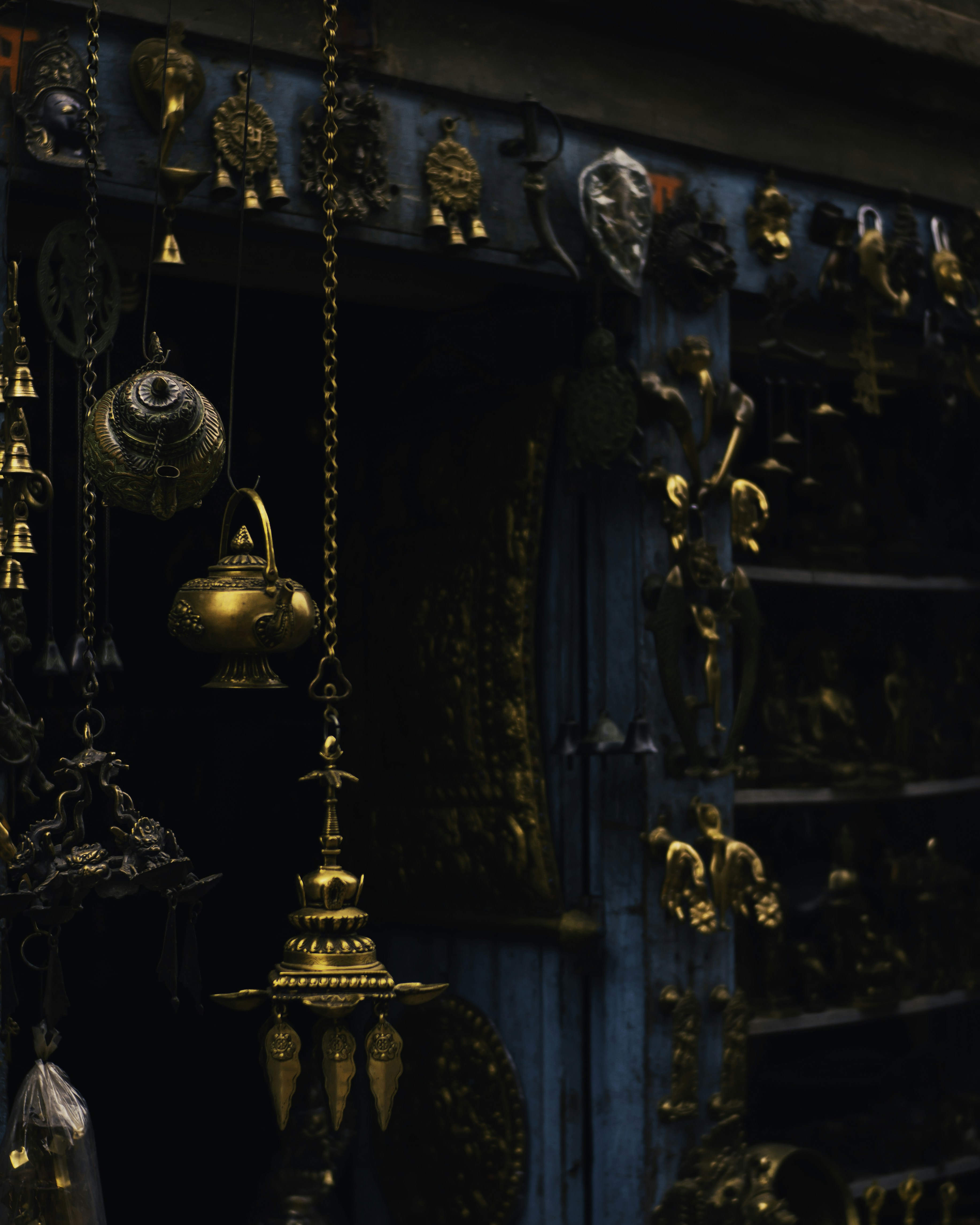 a bunch of bells hanging from a wall