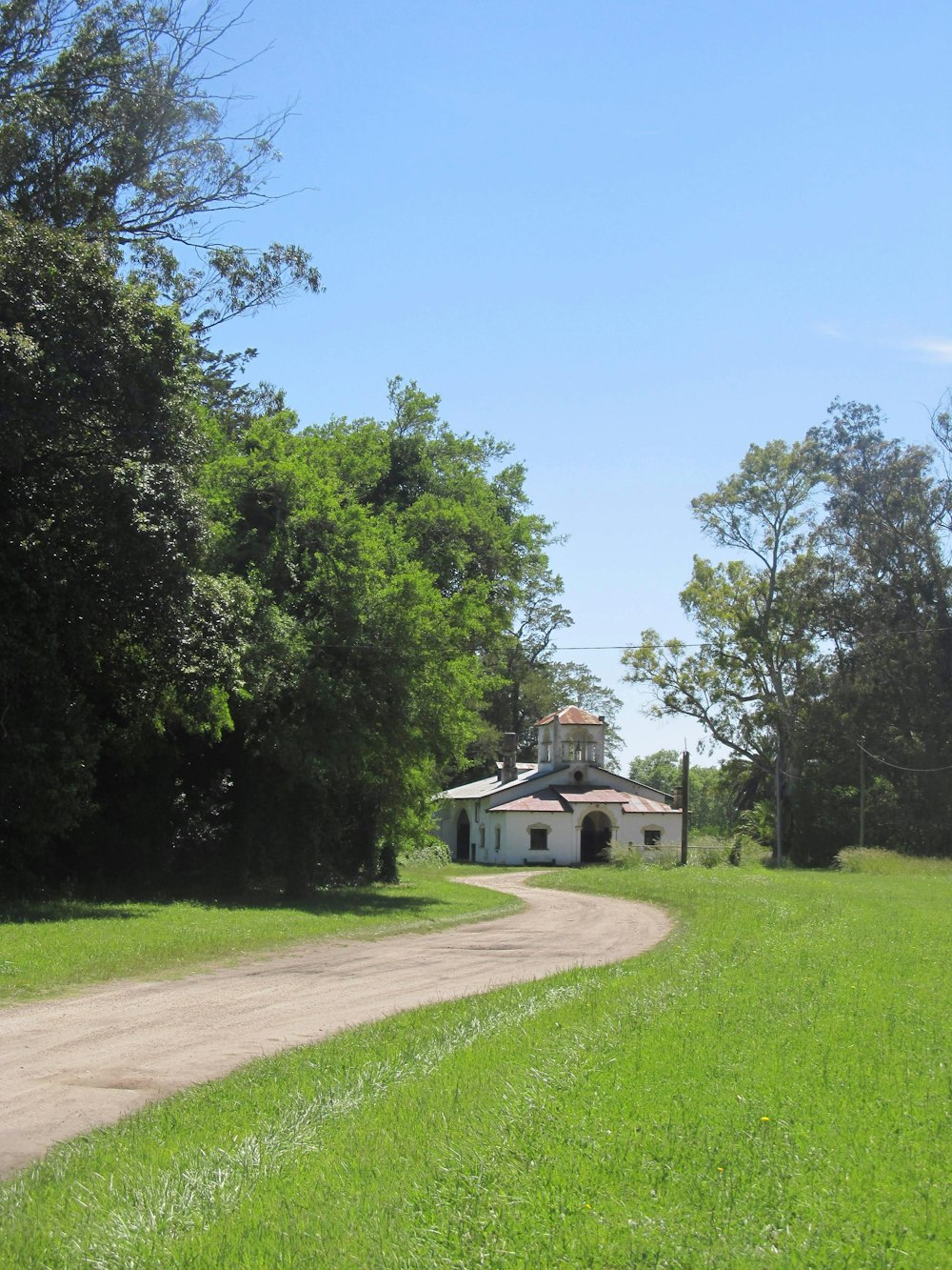 white concrete house near green grass field