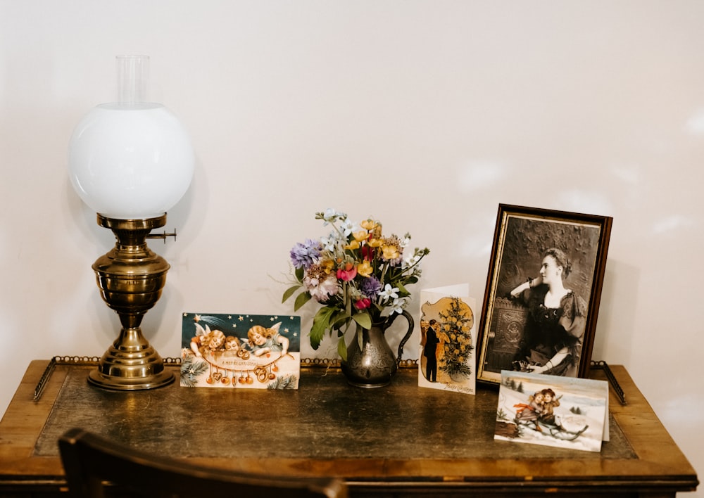 brass-colored and white table lamp