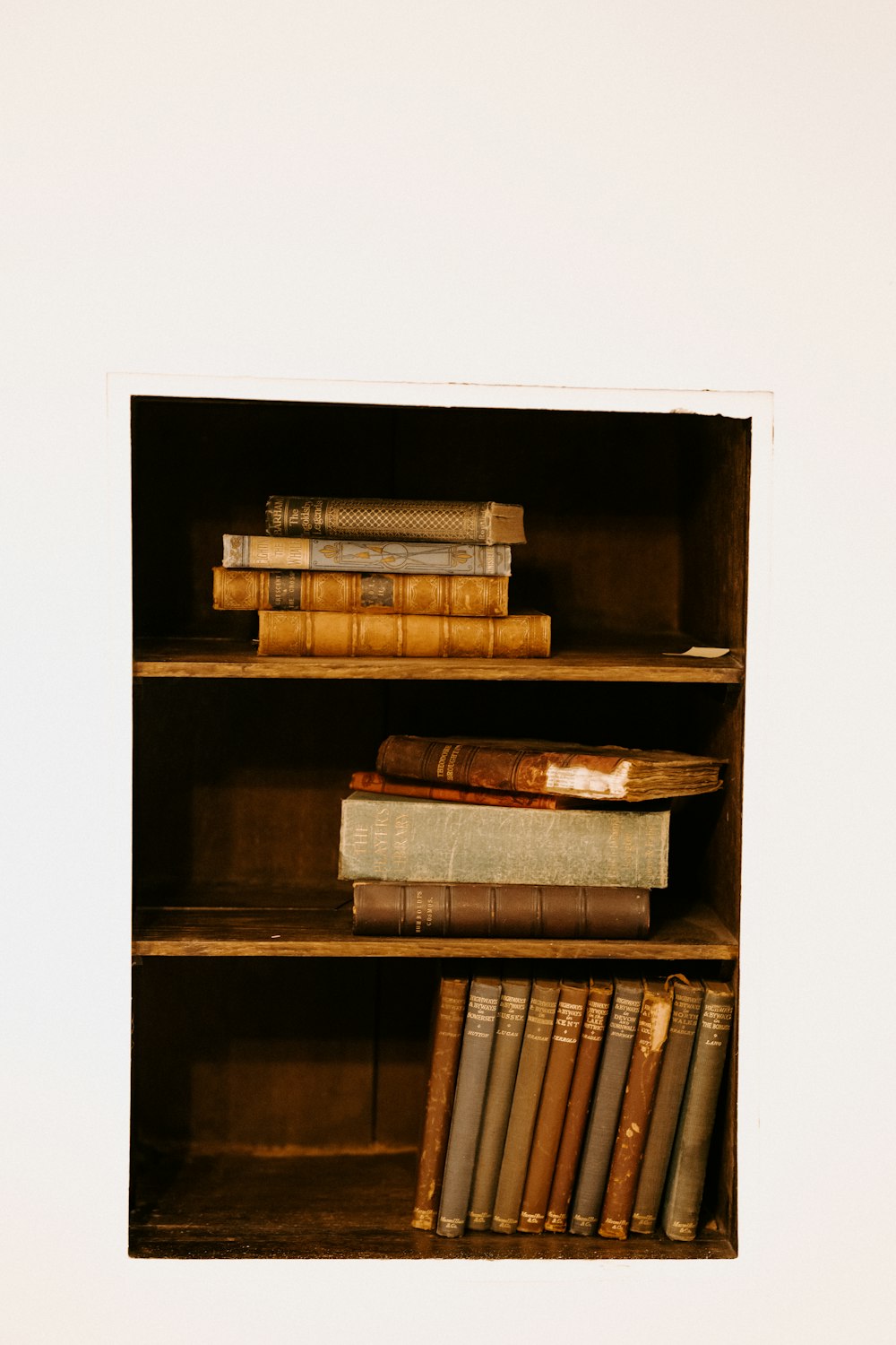 books on brown wooden shelf