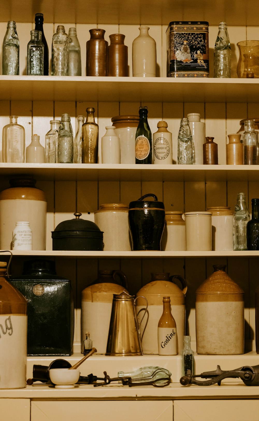 a shelf filled with lots of different types of jars