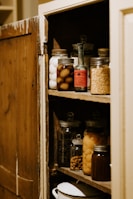 preserve jars on brown wooden shelf